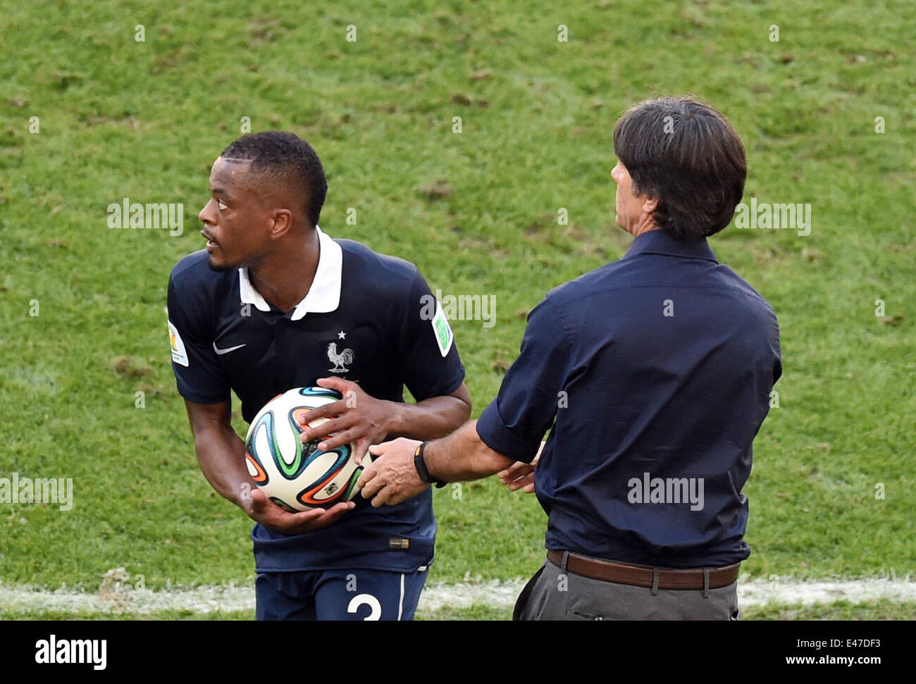 Rio de Janeiro, Brazil. 04th July, 2014. Patrice Evra (L) of France and head coach Joachim Loew of Germany seen during the FIFA World Cup 2014 quarter final soccer match between France and Germany at Estadio do Maracana in Rio de Janeiro, Brazil, 04 July 2014. Photo: Marcus Brandt/dpa/Alamy Live News Stock Photo