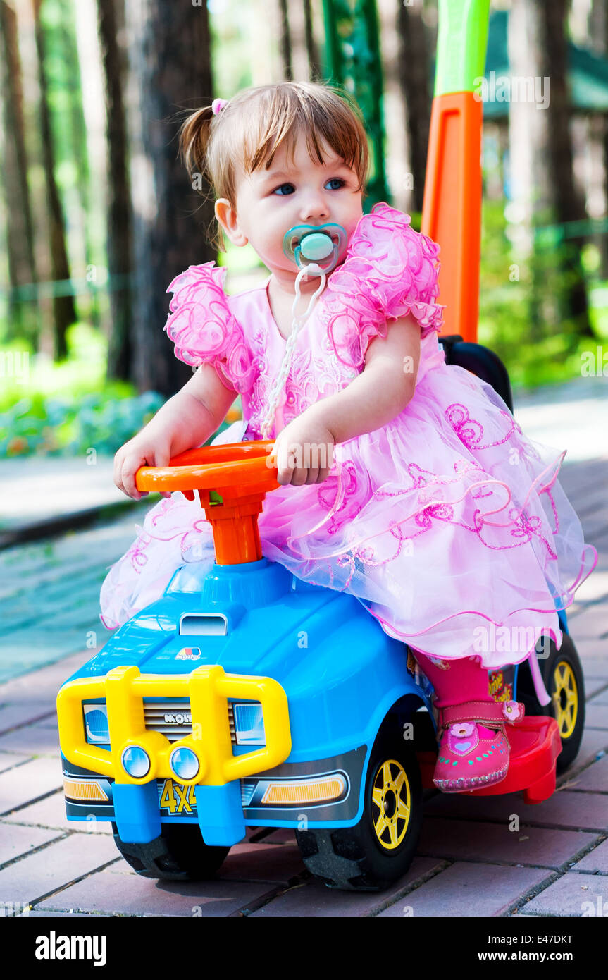 Portrait of a baby girl on toy car Stock Photo Alamy