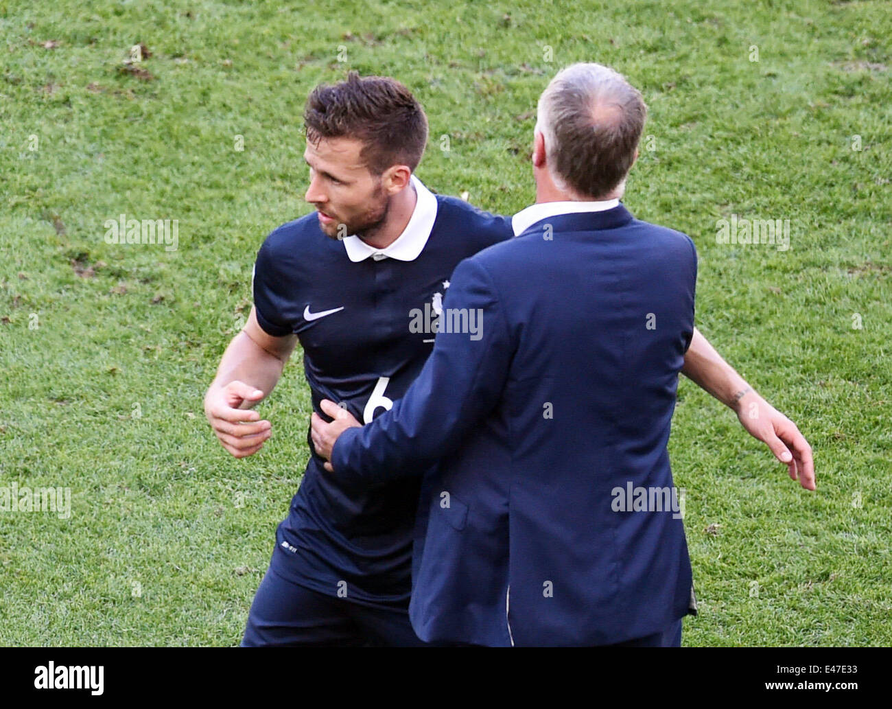 Rio de Janeiro, Brazil. 04th July, 2014. Head coch Didier Deschamps of France hugs his substituted player Yohan Cabaye during the FIFA World Cup 2014 quarter final soccer match between France and Germany at Estadio do Maracana in Rio de Janeiro, Brazil, 04 July 2014. Photo: Marcus Brandt/dpa/Alamy Live News Stock Photo