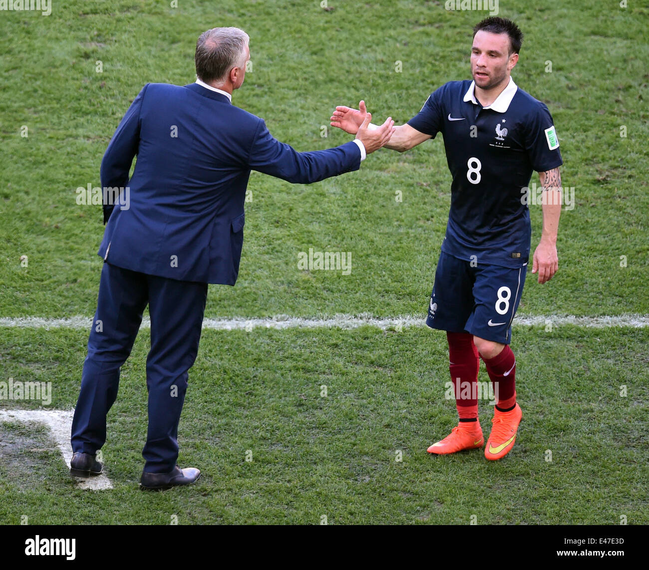 Rio de Janeiro, Brazil. 04th July, 2014. Head coach Didier Deschamps (L) of France shakes hands with Mathieu Valbuena during the FIFA World Cup 2014 quarter final soccer match between France and Germany at Estadio do Maracana in Rio de Janeiro, Brazil, 04 July 2014. Photo: Marcus Brandt/dpa/Alamy Live News Stock Photo