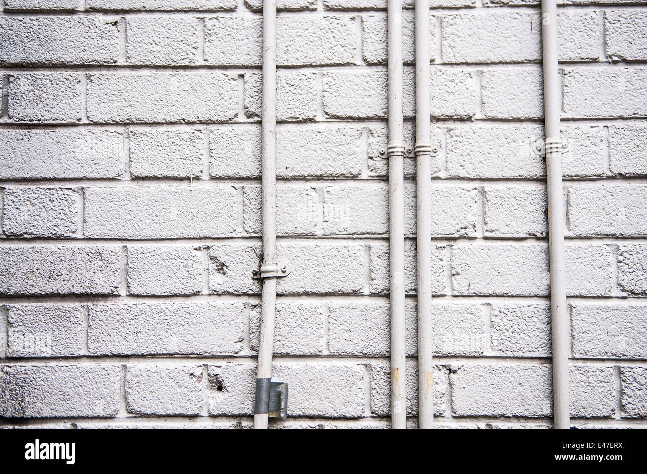 White wall and electrical conduit pipes Stock Photo