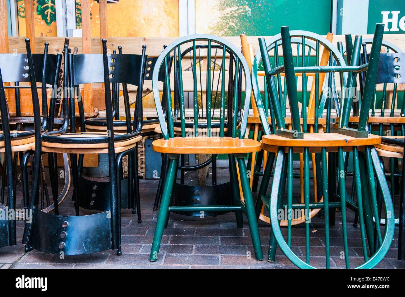 Wooden Chairs Stacked Upside Down Outside A Pub Stock Photo - Alamy