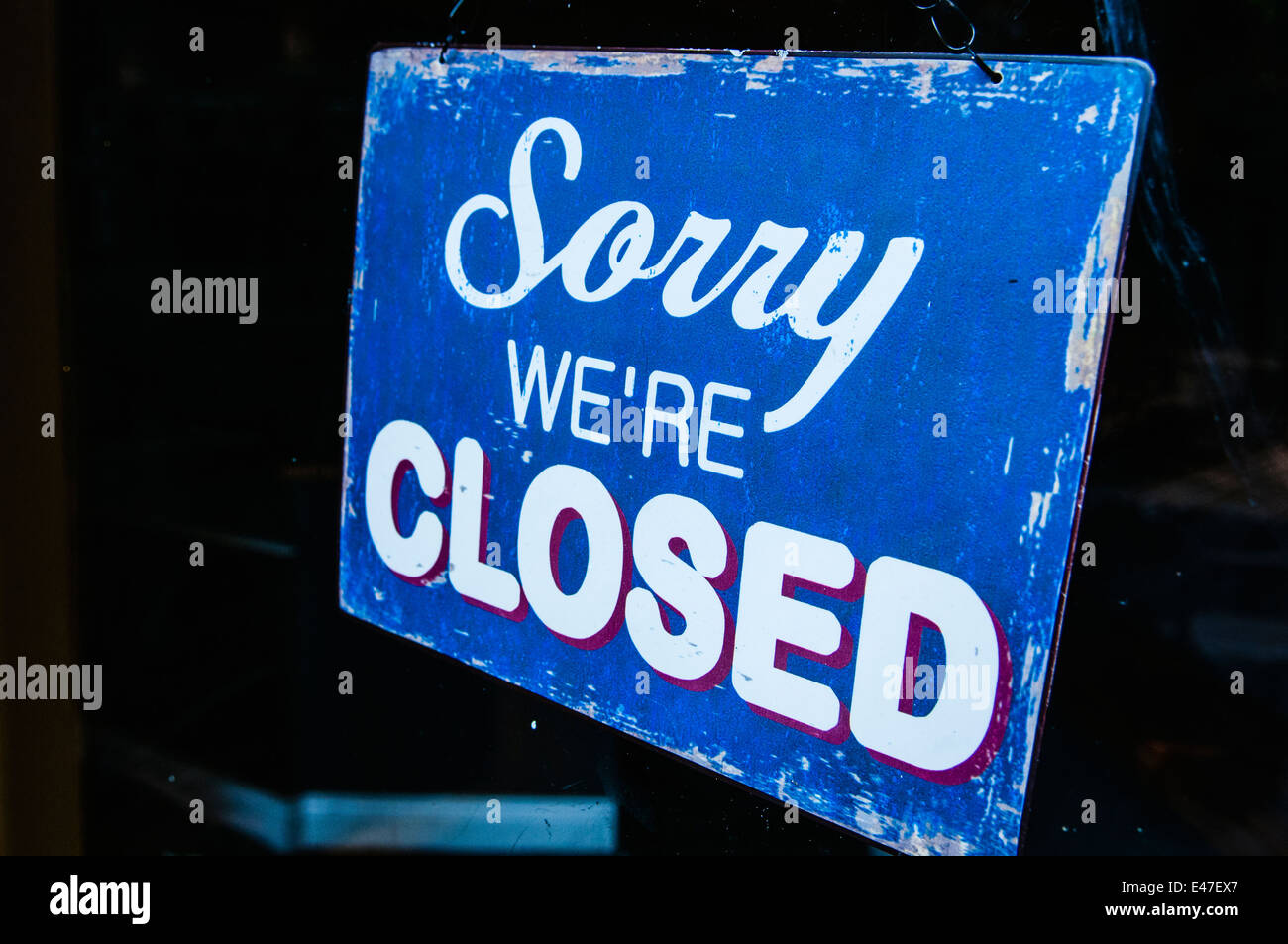 Sign on a shop saying 'Sorry. We're closed' Stock Photo