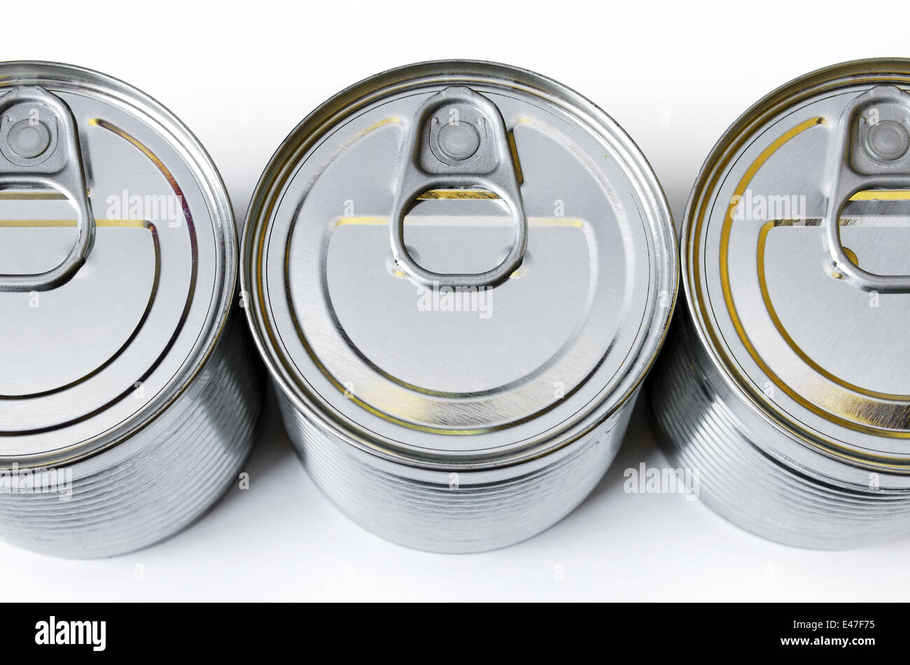 detail of the lids of three cans of conserved food Stock Photo