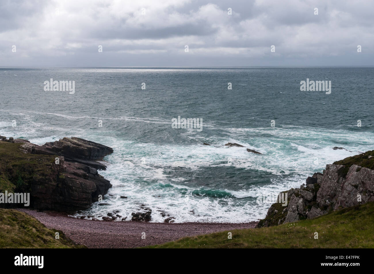Looking out across The Minch towards the Outer Hebrides from Sron na h-Airde Fholaich on a dull, stormy day. Stock Photo