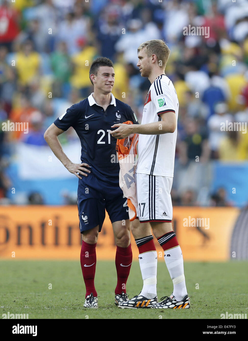 Rio De Janeiro, Brazil. 4th July, 2014. France's Laurent Koscielny speaks with Germany's Per Mertesacker after a quarter-finals match between France and Germany of 2014 FIFA World Cup at the Estadio do Maracana Stadium in Rio de Janeiro, Brazil, on July 4, 2014. Germany won 1-0 over France and qualified for semi-finals on Friday. Credit:  Wang Lili/Xinhua/Alamy Live News Stock Photo
