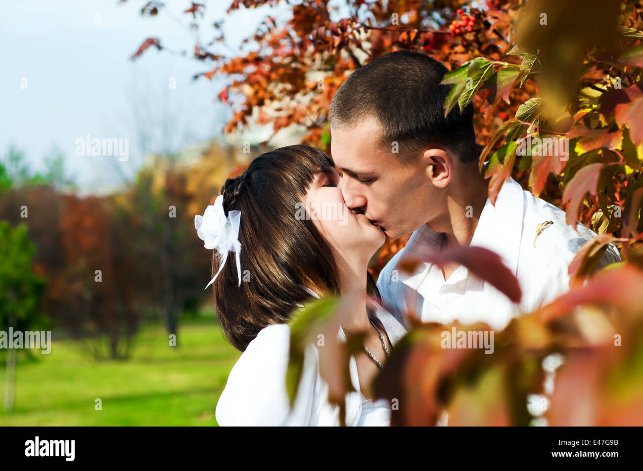 Beautiful european young newlywed couple is kissing, autumn Stock Photo