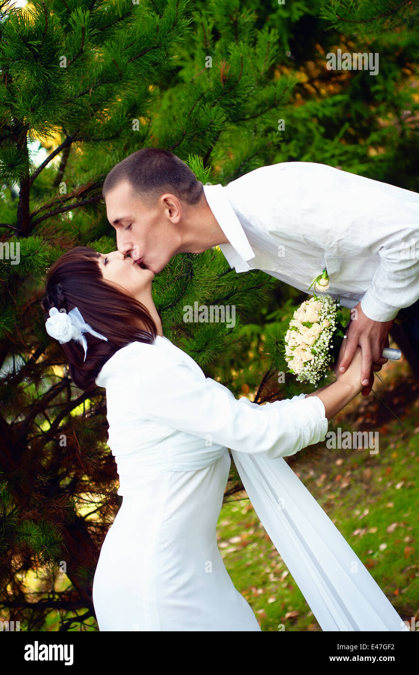 Beautiful european young newlywed couple is kissing Stock Photo