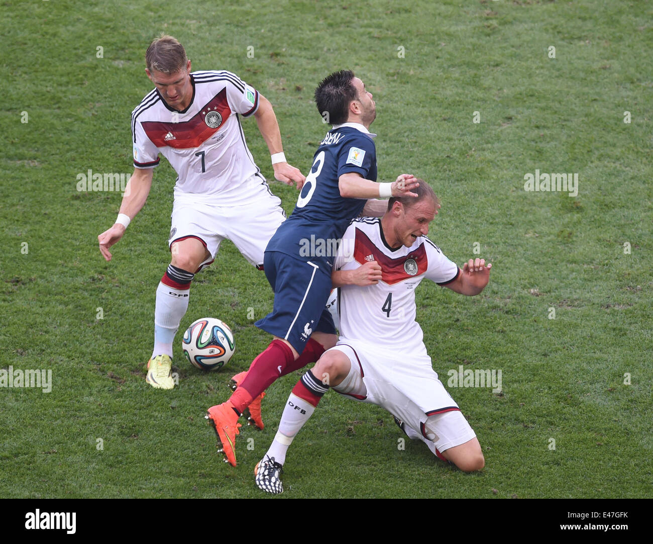 Rio de Janeiro, Brazil. 04th July, 2014. Bastian Schweinsteiger (L) and Benedikt Hoewedes (R) of Germany vie for the ball with Mathieu Valbuena of France during the FIFA World Cup 2014 quarter final soccer match between France and Germany at Estadio do Maracana in Rio de Janeiro, Brazil, 04 July 2014. Photo: Marcus Brandt/dpa/Alamy Live News Stock Photo