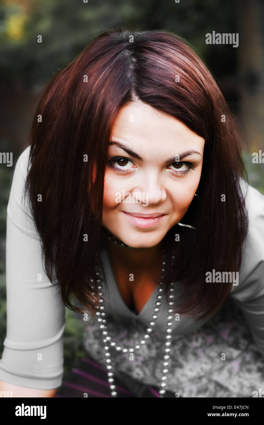Beautiful european brunette girl is sly staring Stock Photo