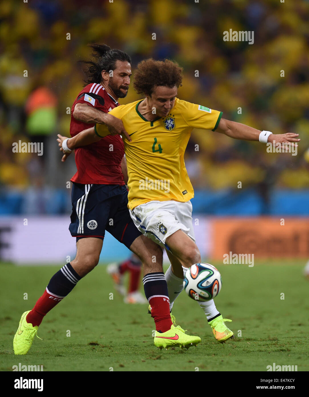 Fortaleza, Brazil. 04th July, 2014. David Luiz of Brazil and Mario Yepes (L) of Colombia vie for the ball during the FIFA World Cup 2014 quarter final match soccer between Brazil and Colombia at the Estadio Castelao in Fortaleza, Brazil, 04 July 2014. Photo: Marius Becker/dpa/Alamy Live News Stock Photo