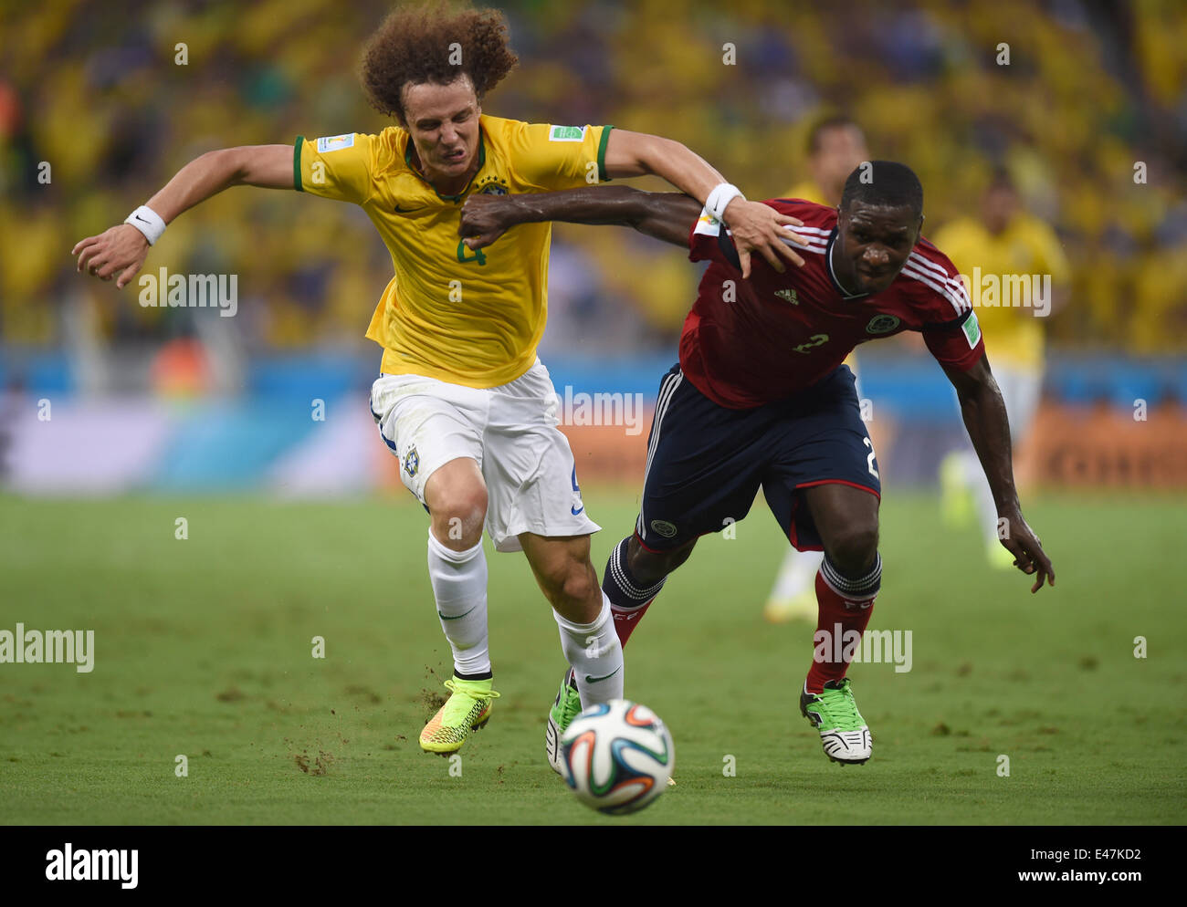 Fortaleza, Brazil. 04th July, 2014. David Luiz (L) of Brazil and Cristian Zapata of Colombia vie for the ball during the FIFA World Cup 2014 quarter final match soccer between Brazil and Colombia at the Estadio Castelao in Fortaleza, Brazil, 04 July 2014. Photo: Marius Becker/dpa/Alamy Live News Stock Photo