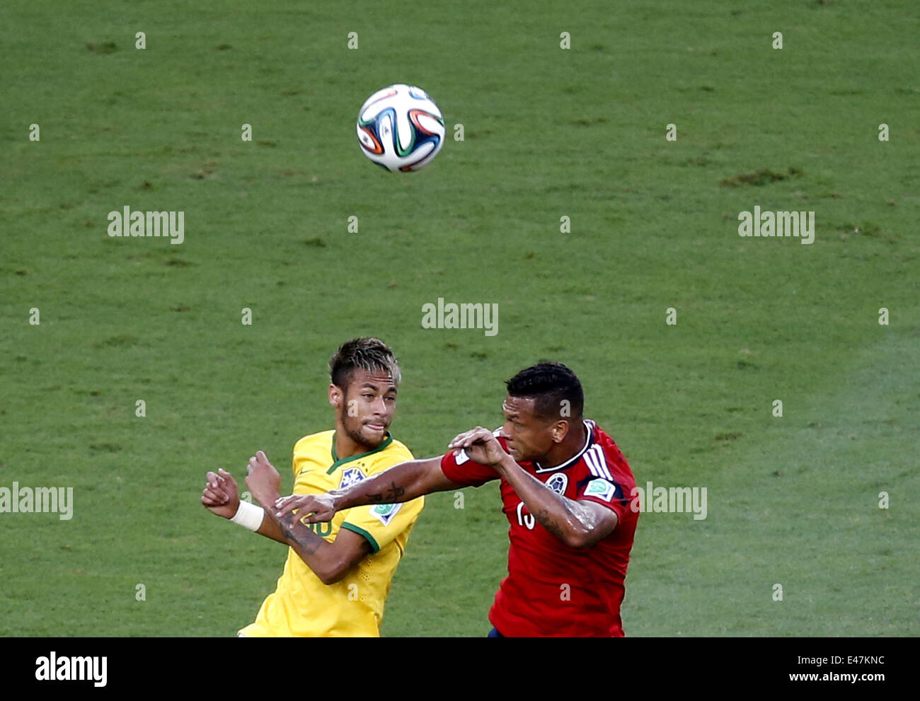 Fortaleza, Brazil. 4th July, 2014. Brazil's Neymar (L) competes for a header with Colombia's Freddy Guarin during a quarter-finals match between Brazil and Colombia of 2014 FIFA World Cup at the Estadio Castelao Stadium in Fortaleza, Brazil, on July 4, 2014. Credit:  Liao Yujie/Xinhua/Alamy Live News Stock Photo