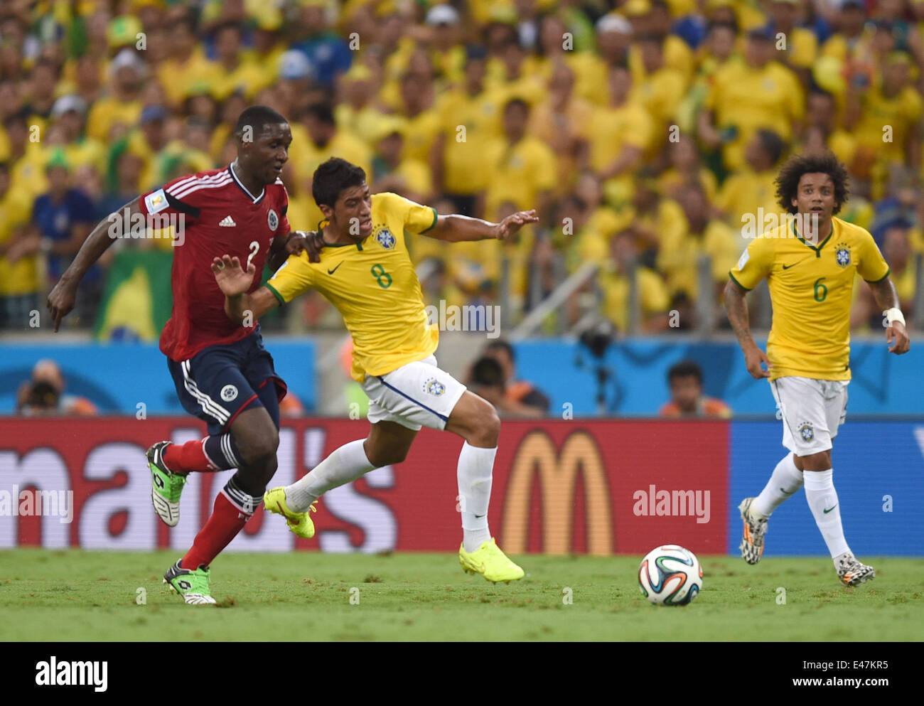 Fortaleza, Brazil. 04th July, 2014. Paulinho (C) of Brazil and Cristian Zapata (L) of Colombia vie for the ball during the FIFA World Cup 2014 quarter final match soccer between Brazil and Colombia at the Estadio Castelao in Fortaleza, Brazil, 04 July 2014. Photo: Marius Becker/dpa/Alamy Live News Stock Photo