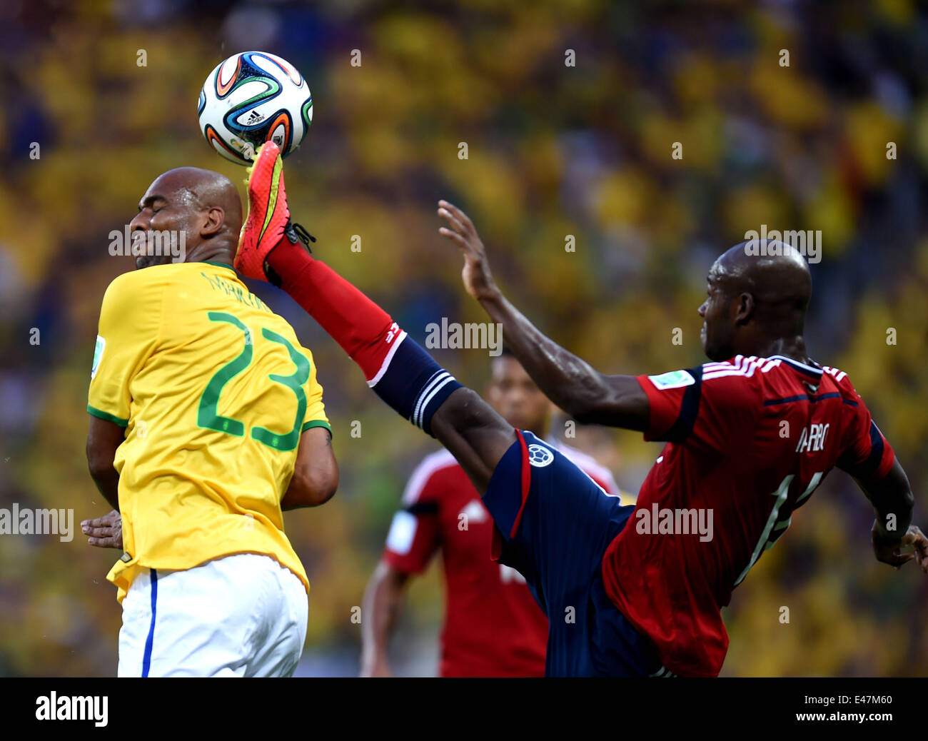Fortaleza, Brazil. 4th July, 2014. Brazil's Maicon (L) vies with Colombia's Victor Ibarbo during a quarter-finals match between Brazil and Colombia of 2014 FIFA World Cup at the Estadio Castelao Stadium in Fortaleza, Brazil, on July 4, 2014. Credit:  Li Ga/Xinhua/Alamy Live News Stock Photo