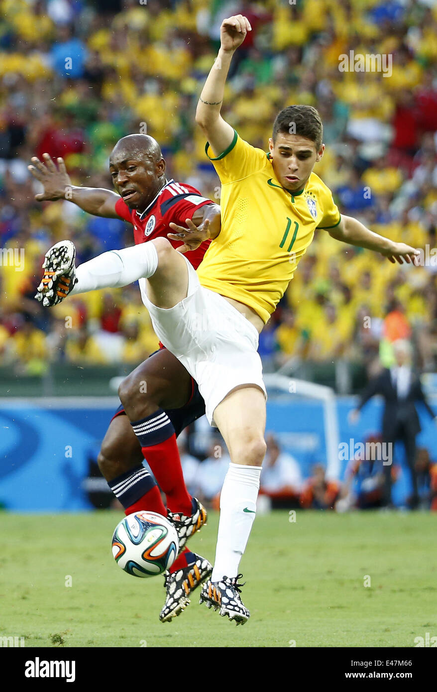 Fortaleza, Brazil. 4th July, 2014. Brazil's Oscar vies with Colombia's Pablo Armero during a quarter-finals match between Brazil and Colombia of 2014 FIFA World Cup at the Estadio Castelao Stadium in Fortaleza, Brazil, on July 4, 2014. Credit:  Chen Jianli/Xinhua/Alamy Live News Stock Photo