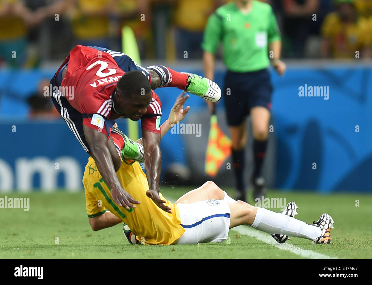 Fortaleza, Brazil. 4th July, 2014. Colombia's Cristian Zapata (front) falls down in a competition with Brazil's Oscar during a quarter-finals match between Brazil and Colombia of 2014 FIFA World Cup at the Estadio Castelao Stadium in Fortaleza, Brazil, on July 4, 2014. Credit:  Li Ga/Xinhua/Alamy Live News Stock Photo