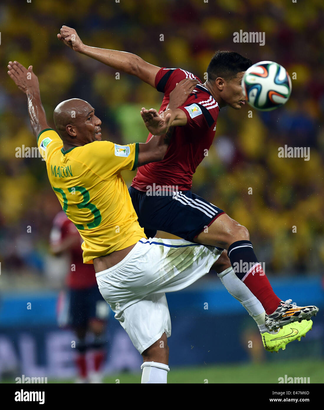 Fortaleza, Brazil. 4th July, 2014. Brazil's Maicon (L) competes during a quarter-finals match between Brazil and Colombia of 2014 FIFA World Cup at the Estadio Castelao Stadium in Fortaleza, Brazil, on July 4, 2014. Credit:  Li Ga/Xinhua/Alamy Live News Stock Photo