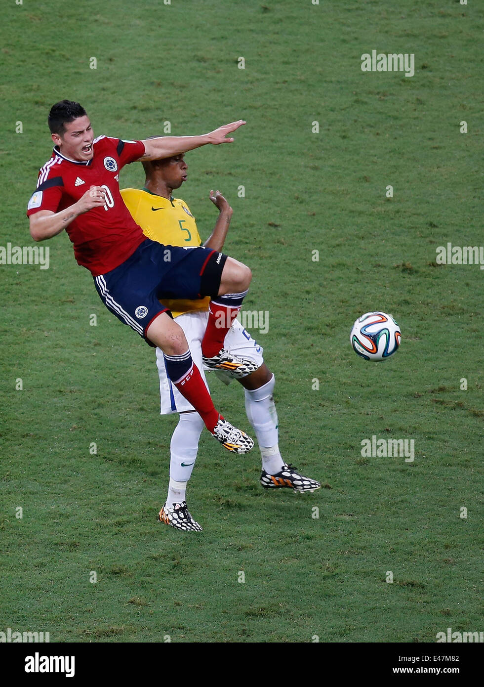 Fortaleza, Brazil. 4th July, 2014. Brazil's Fernandinho (R) vies with Colombia's James Rodriguez during a quarter-finals match between Brazil and Colombia of 2014 FIFA World Cup at the Estadio Castelao Stadium in Fortaleza, Brazil, on July 4, 2014. Credit:  Liao Yujie/Xinhua/Alamy Live News Stock Photo