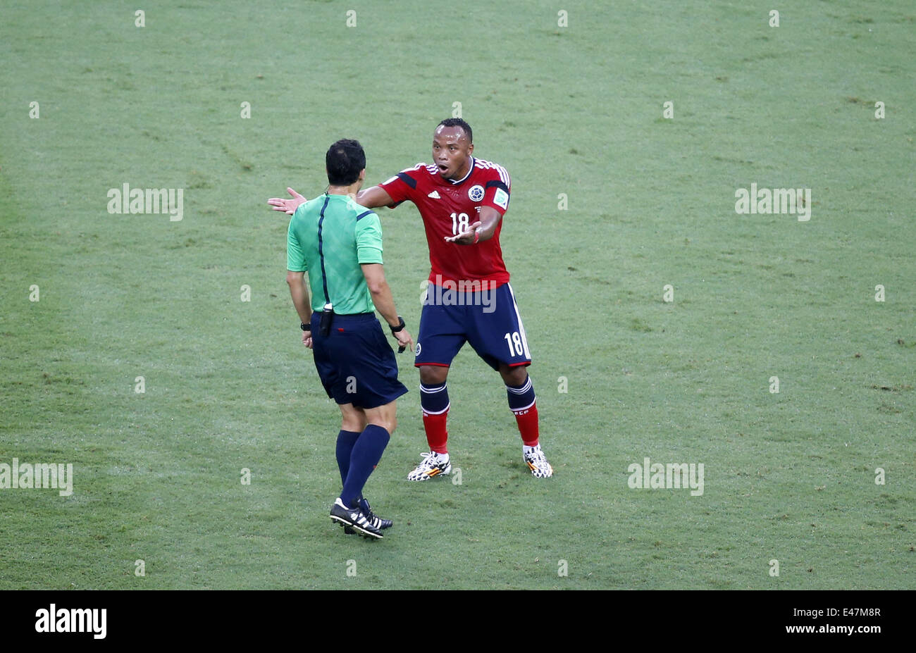 Fortaleza, Brazil. 4th July, 2014. Colombia's Juan Zuniga (R) argues with Spain's referee Carlos Velasco Carballo during a quarter-finals match between Brazil and Colombia of 2014 FIFA World Cup at the Estadio Castelao Stadium in Fortaleza, Brazil, on July 4, 2014. Credit:  Liao Yujie/Xinhua/Alamy Live News Stock Photo