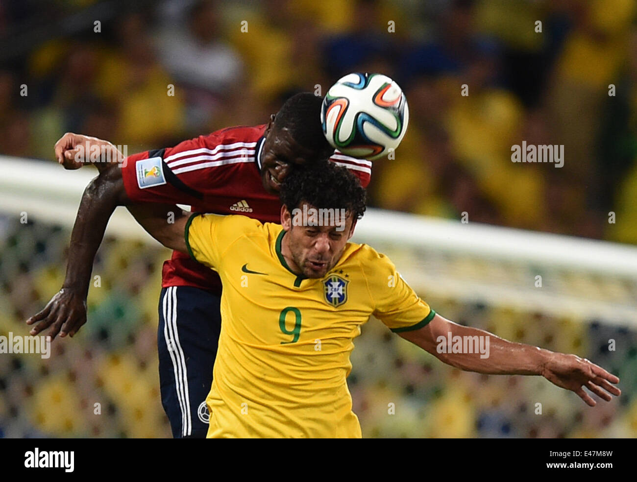 Fortaleza, Brazil. 04th July, 2014. Fred of Brazil and Pablo Armero (back) of Colombia vie for the ball during the FIFA World Cup 2014 quarter final match soccer between Brazil and Colombia at the Estadio Castelao in Fortaleza, Brazil, 04 July 2014. Photo: Marius Becker/dpa/Alamy Live News Stock Photo