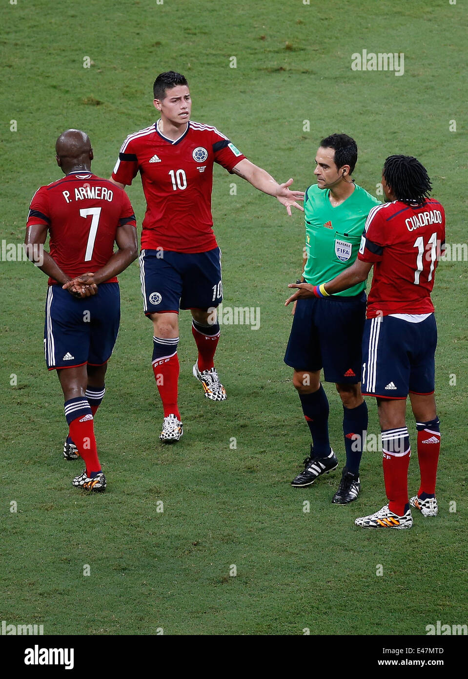 Fortaleza, Brazil. 4th July, 2014. Colombia's James Rodriguez (2nd L) and Juan Guillermo Cuadrado (1st R) argue with Spain's referee Carlos Velasco Carballo (2nd R) during a quarter-finals match between Brazil and Colombia of 2014 FIFA World Cup at the Estadio Castelao Stadium in Fortaleza, Brazil, on July 4, 2014. Credit:  Liao Yujie/Xinhua/Alamy Live News Stock Photo