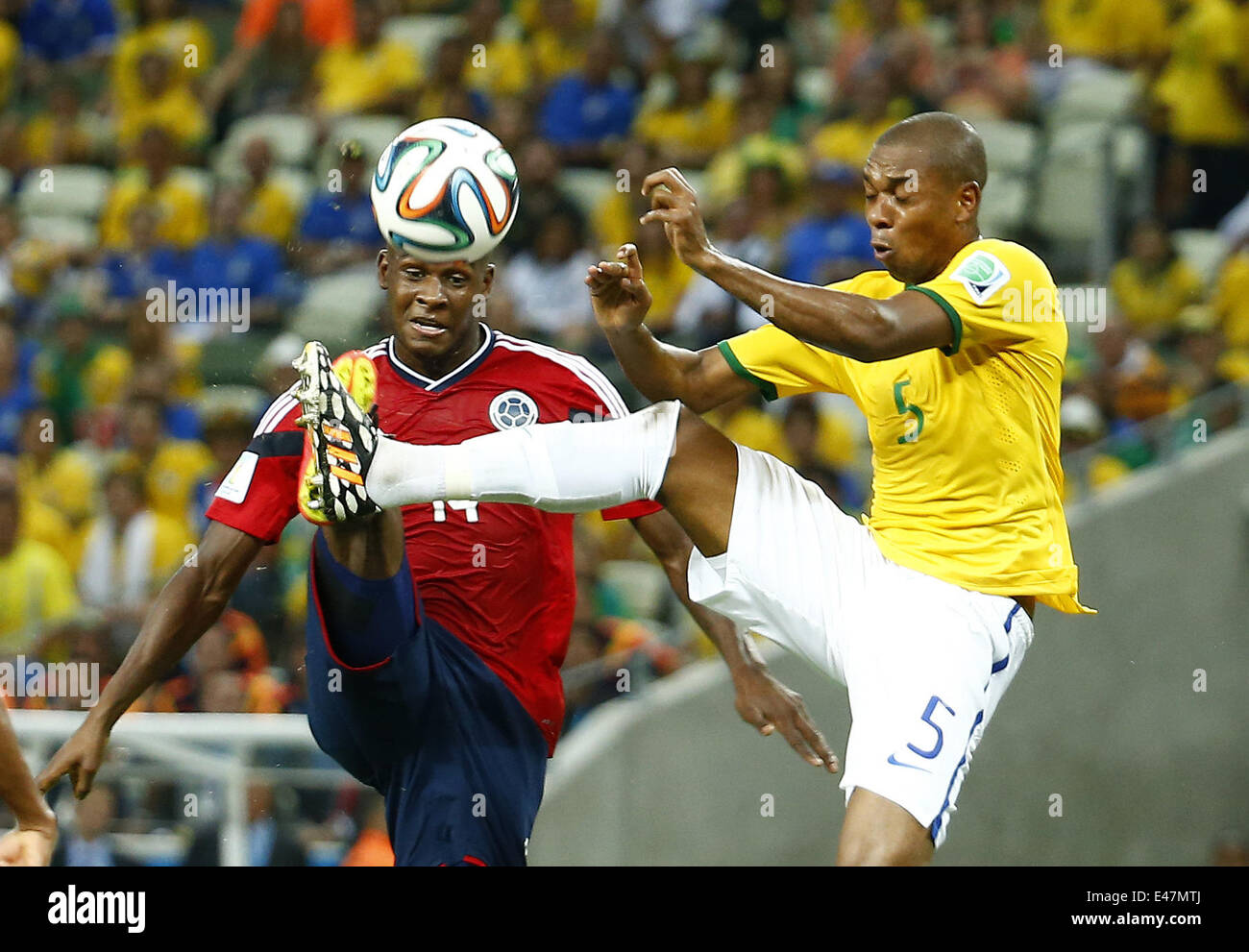 Fortaleza, Brazil. 4th July, 2014. Brazil's Fernandinho vies with Colombia's Victor Ibarbo during a quarter-finals match between Brazil and Colombia of 2014 FIFA World Cup at the Estadio Castelao Stadium in Fortaleza, Brazil, on July 4, 2014. Credit:  Chen Jianli/Xinhua/Alamy Live News Stock Photo