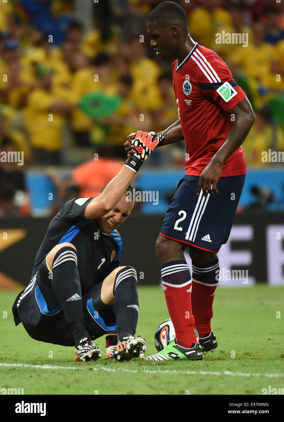 Fortaleza, Brazil. 4th July, 2014. Colombia's Cristian Zapata (R) helps goalkeeper David Ospina get up during a quarter-finals match between Brazil and Colombia of 2014 FIFA World Cup at the Estadio Castelao Stadium in Fortaleza, Brazil, on July 4, 2014. Credit:  Li Ga/Xinhua/Alamy Live News Stock Photo