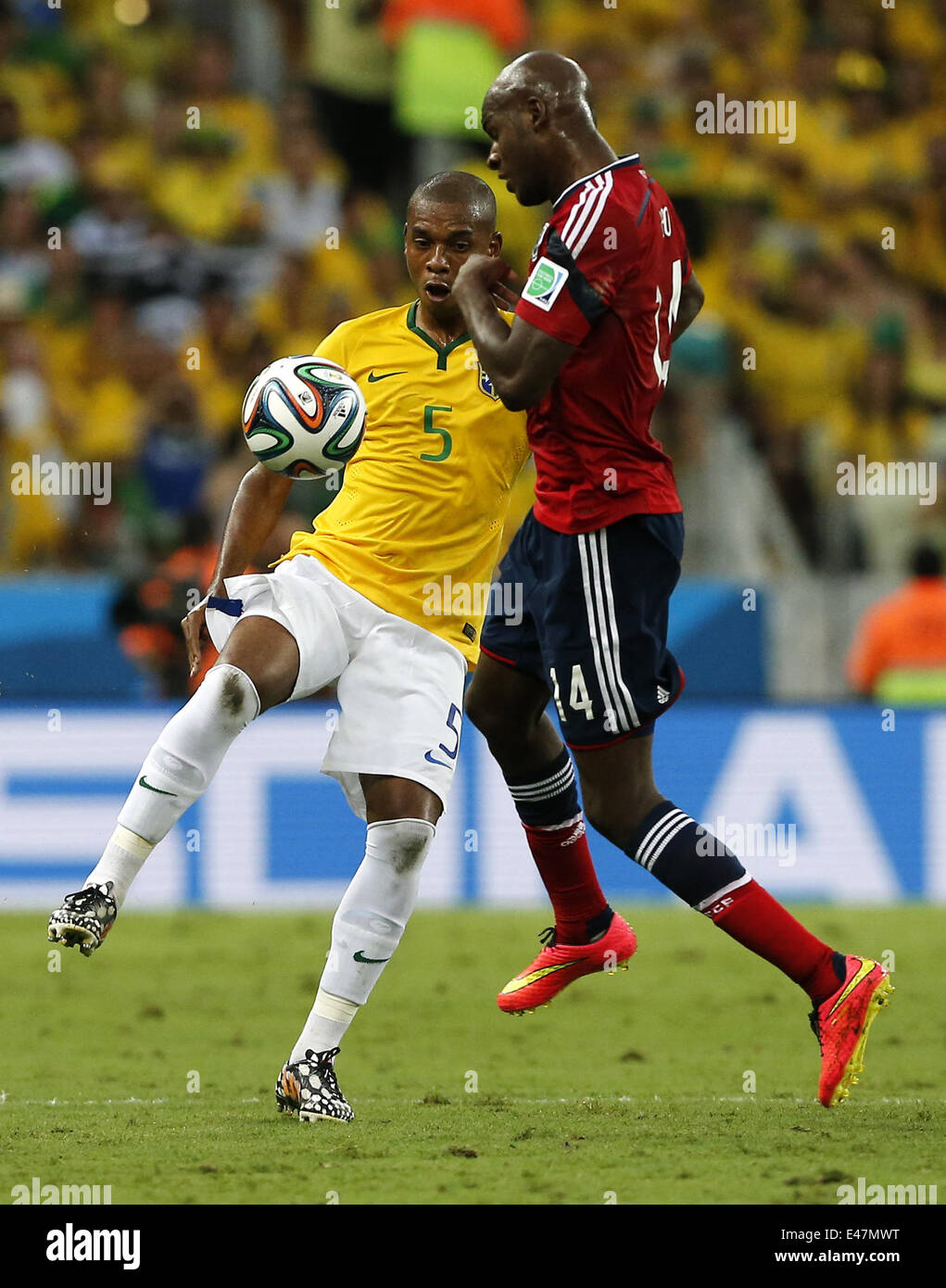 Fortaleza, Brazil. 4th July, 2014. Brazil's Fernandinho vies with Colombia's Victor Ibarbo during a quarter-finals match between Brazil and Colombia of 2014 FIFA World Cup at the Estadio Castelao Stadium in Fortaleza, Brazil, on July 4, 2014. Credit:  Zhou Lei/Xinhua/Alamy Live News Stock Photo