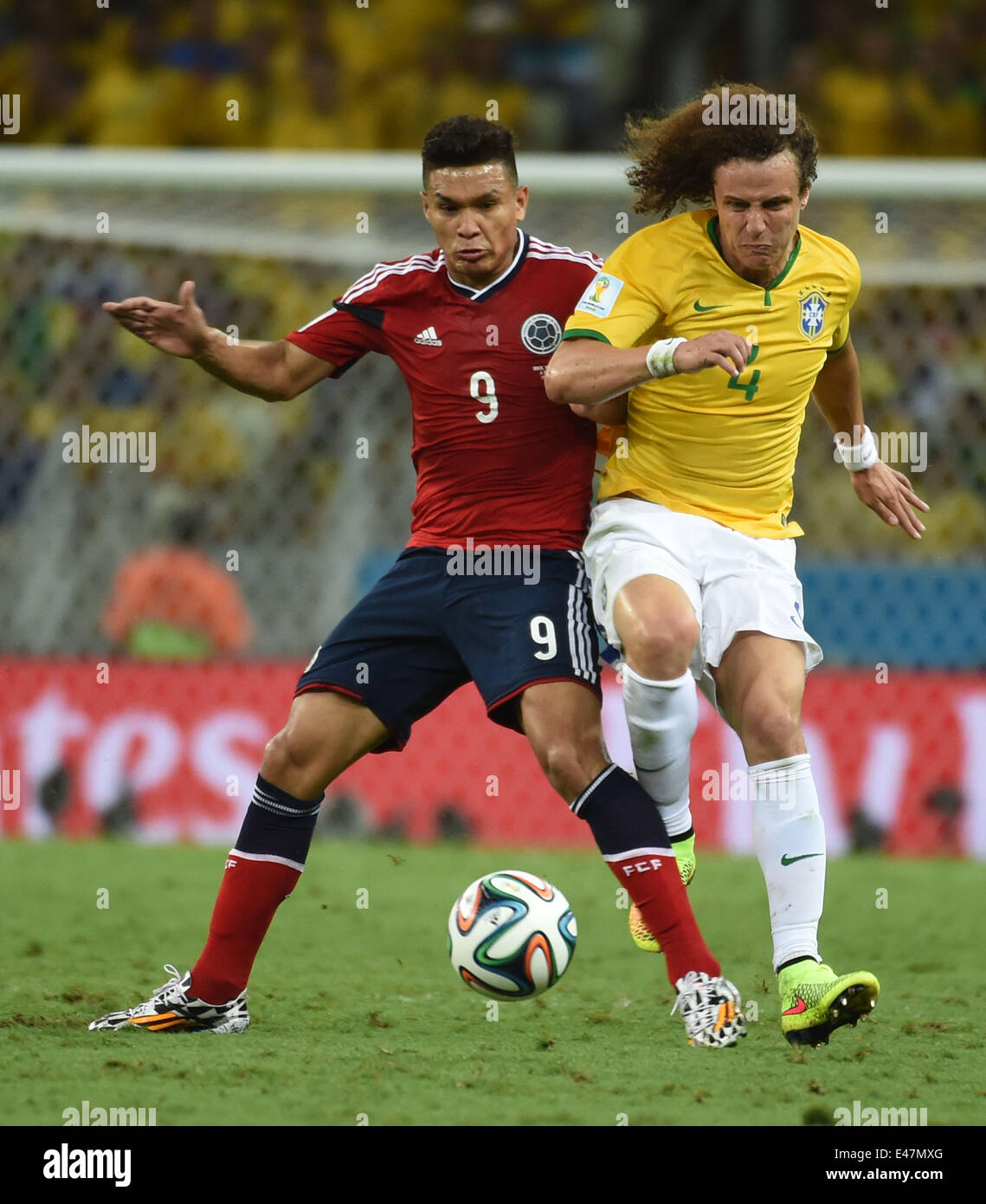 Fortaleza, Brazil. 4th July, 2014. Brazil's David Luiz (R) vies with Colombia's Teofilo Gutierrez during a quarter-finals match between Brazil and Colombia of 2014 FIFA World Cup at the Estadio Castelao Stadium in Fortaleza, Brazil, on July 4, 2014. Credit:  Li Ga/Xinhua/Alamy Live News Stock Photo