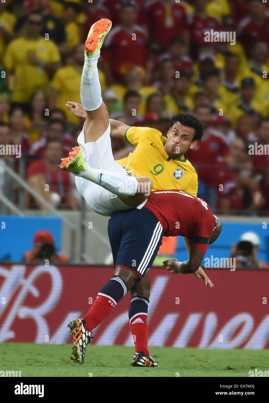 Fortaleza, Brazil. 4th July, 2014. Brazil's Fred (up) vies with Colombia's Pablo Armero during a quarter-finals match between Brazil and Colombia of 2014 FIFA World Cup at the Estadio Castelao Stadium in Fortaleza, Brazil, on July 4, 2014. Credit:  Li Ga/Xinhua/Alamy Live News Stock Photo