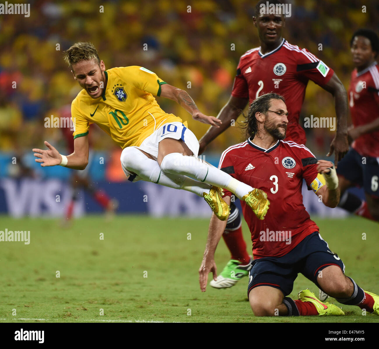 Fortaleza, Brazil. 4th July, 2014. Brazil's Neymar (L) falls down in a competition with Colombia's Mario Yepes during a quarter-finals match between Brazil and Colombia of 2014 FIFA World Cup at the Estadio Castelao Stadium in Fortaleza, Brazil, on July 4, 2014. Credit:  Li Ga/Xinhua/Alamy Live News Stock Photo