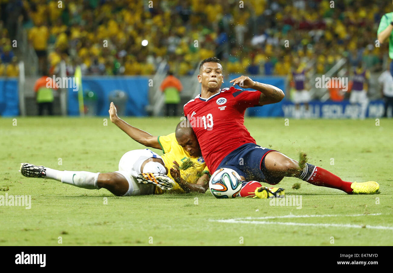 Fortaleza, Brazil. 4th July, 2014. Brazil's Fernandinho vies with Colombia's Freddy Guarin during a quarter-finals match between Brazil and Colombia of 2014 FIFA World Cup at the Estadio Castelao Stadium in Fortaleza, Brazil, on July 4, 2014. Credit:  Chen Jianli/Xinhua/Alamy Live News Stock Photo