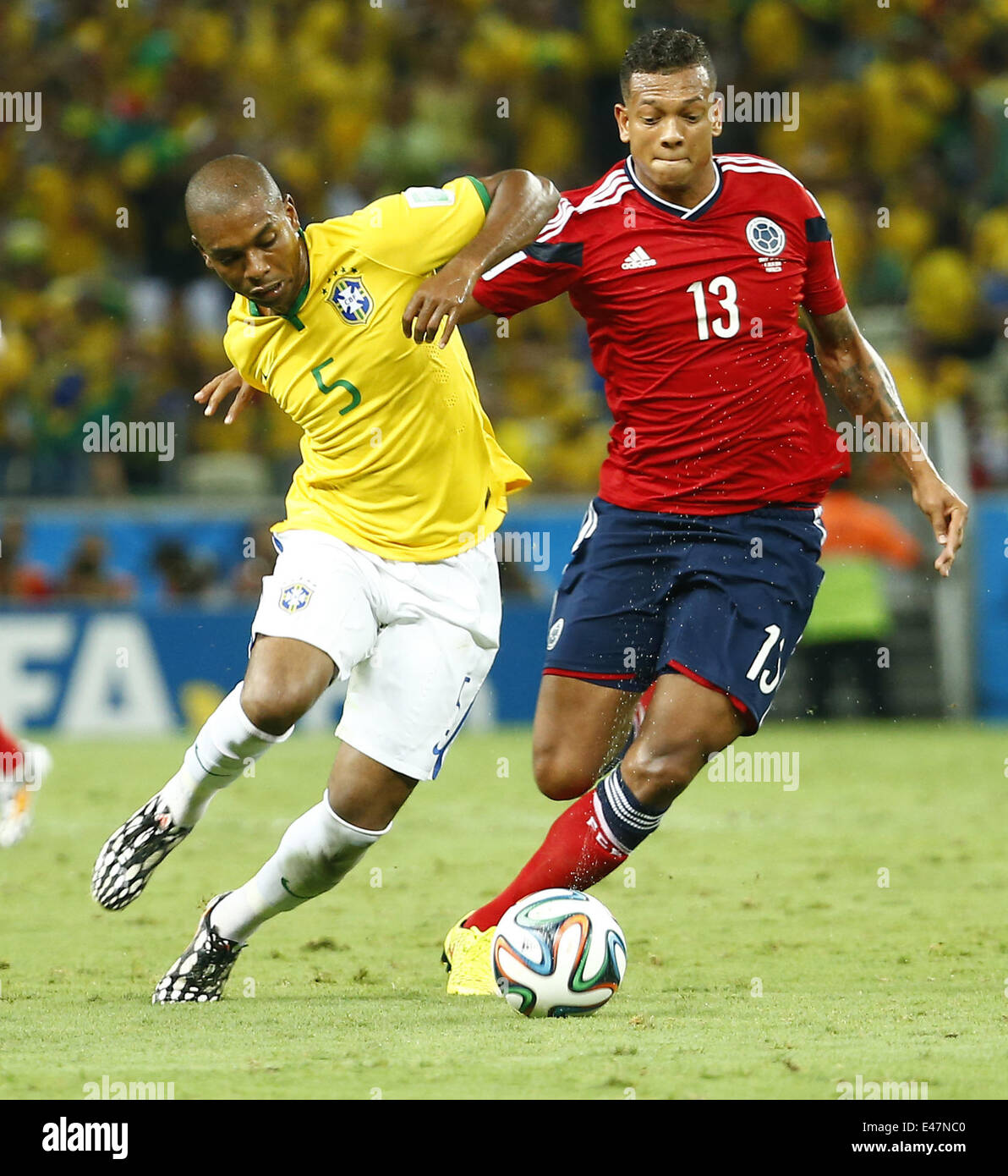 Fortaleza, Brazil. 4th July, 2014. Brazil's Fernandinho vies with Colombia's Freddy Guarin during a quarter-finals match between Brazil and Colombia of 2014 FIFA World Cup at the Estadio Castelao Stadium in Fortaleza, Brazil, on July 4, 2014. Credit:  Chen Jianli/Xinhua/Alamy Live News Stock Photo