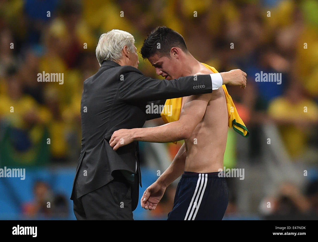 Fortaleza, Brazil. 04th July, 2014. Head coach Jose Pekerman (L) of Colombia hugs his player James Rodriguez after the FIFA World Cup 2014 quarter final match soccer between Brazil and Colombia at the Estadio Castelao in Fortaleza, Brazil, 04 July 2014. Photo: Marius Becker/dpa/Alamy Live News Stock Photo