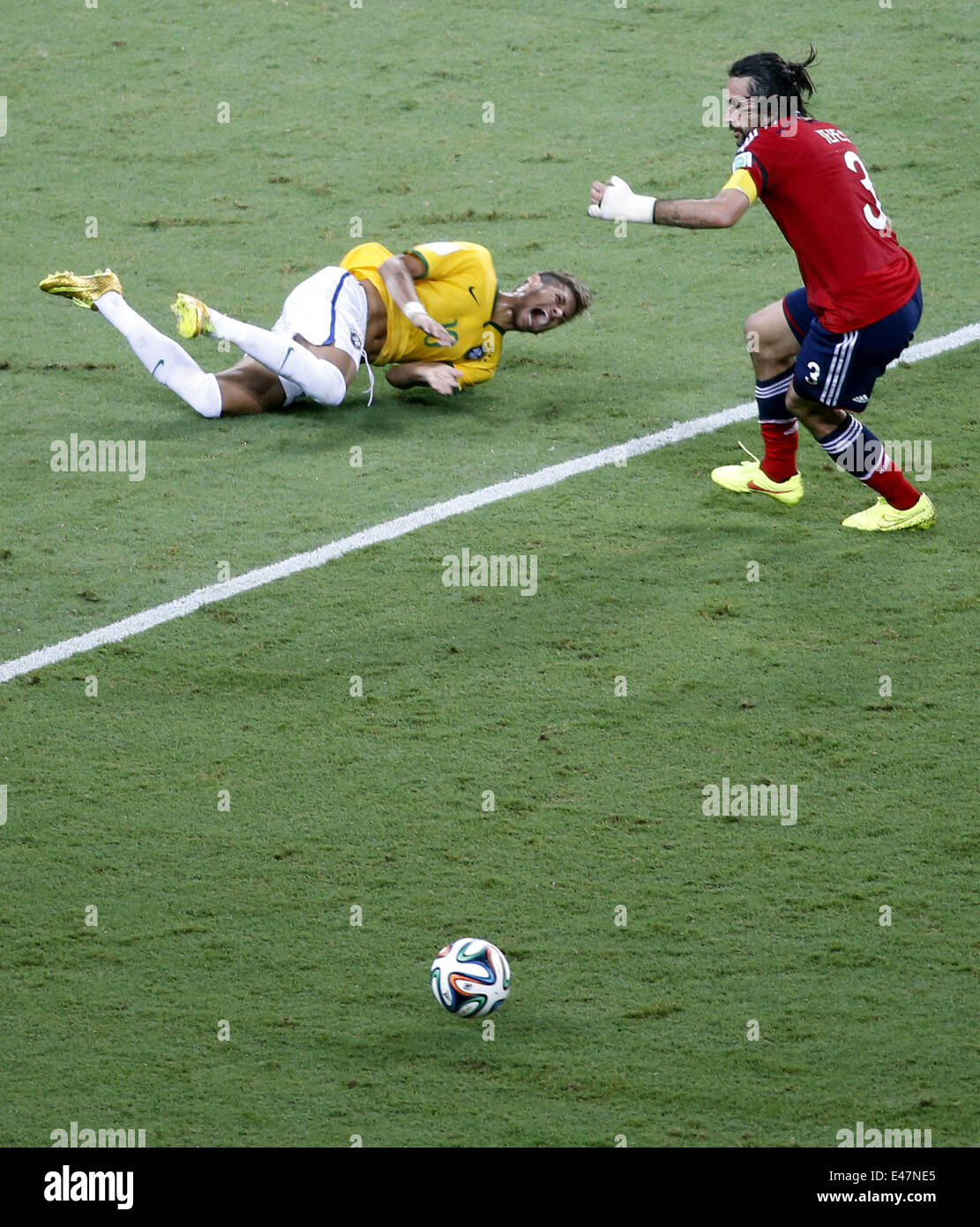 Fortaleza, Brazil. 4th July, 2014. Brazil's Neymar (L) falls down during a quarter-finals match between Brazil and Colombia of 2014 FIFA World Cup at the Estadio Castelao Stadium in Fortaleza, Brazil, on July 4, 2014. Brazil won 2-1 over Colombia and qualified for semi-finals on Friday. Credit:  Liao Yujie/Xinhua/Alamy Live News Stock Photo