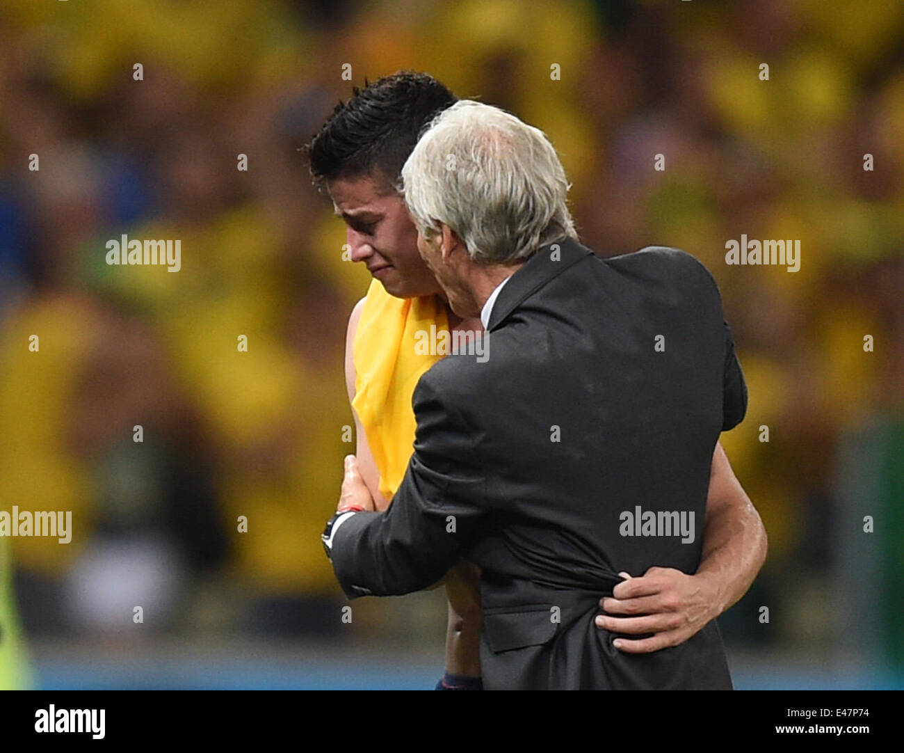 Fortaleza, Brazil. 04th July, 2014. Head coach Jose Pekerman (R) of Colombia hugs his player James Rodriguez after the FIFA World Cup 2014 quarter final match soccer between Brazil and Colombia at the Estadio Castelao in Fortaleza, Brazil, 04 July 2014. Photo: Marius Becker/dpa/Alamy Live News Stock Photo