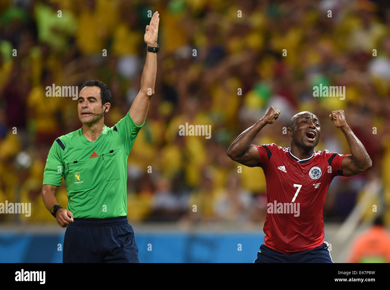 Fortaleza, Brazil. 04th July, 2014. Pablo Armero (R) of Colombia reacts next to referee Carlos Velasco Carballo of Spain during the FIFA World Cup 2014 quarter final match soccer between Brazil and Colombia at the Estadio Castelao in Fortaleza, Brazil, 04 July 2014. Photo: Marius Becker/dpa/Alamy Live News Stock Photo