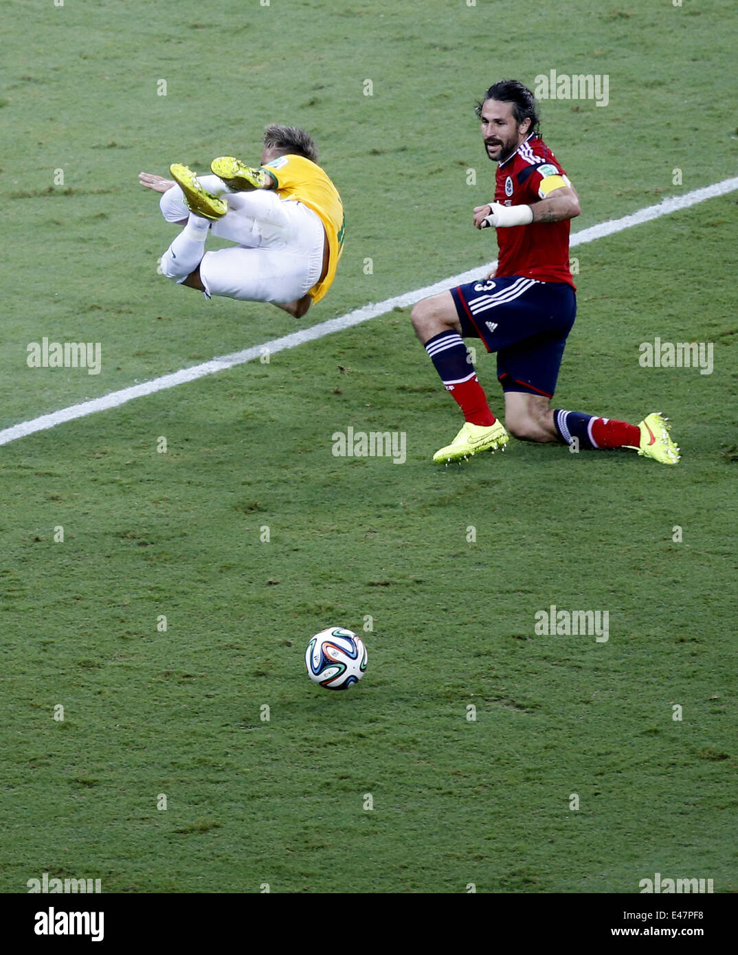 Fortaleza, Brazil. 4th July, 2014. Brazil's Neymar (L) falls down during a quarter-finals match between Brazil and Colombia of 2014 FIFA World Cup at the Estadio Castelao Stadium in Fortaleza, Brazil, on July 4, 2014. Brazil won 2-1 over Colombia and qualified for semi-finals on Friday. Credit:  Liao Yujie/Xinhua/Alamy Live News Stock Photo