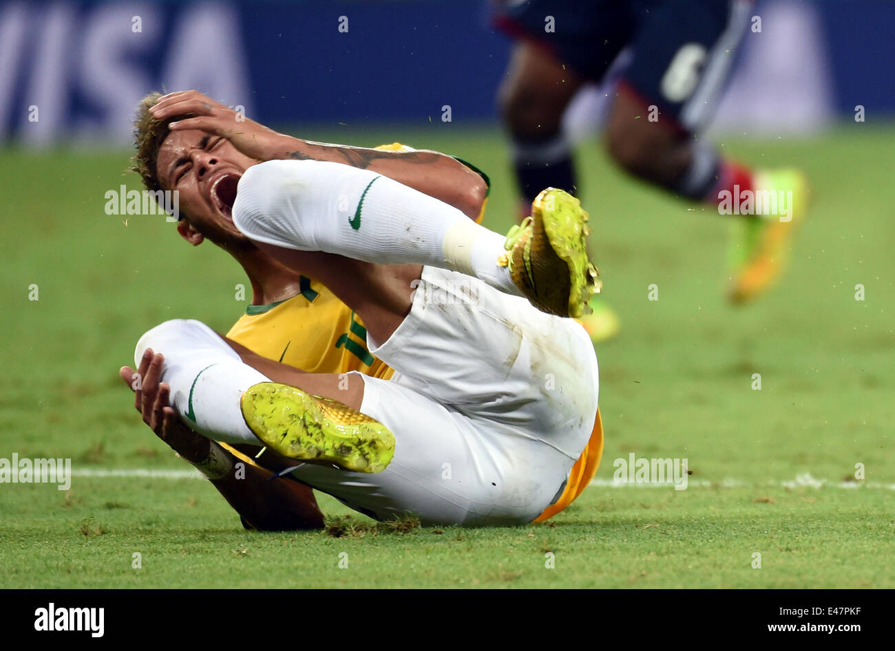 Fortaleza, Brazil. 4th July, 2014. Brazil's Neymar reacts after being hit on the back during a quarter-finals match between Brazil and Colombia of 2014 FIFA World Cup at the Estadio Castelao Stadium in Fortaleza, Brazil, on July 4, 2014. Brazil won 2-1 over Colombia and qualified for semi-finals on Friday. Credit:  Li Ga/Xinhua/Alamy Live News Stock Photo