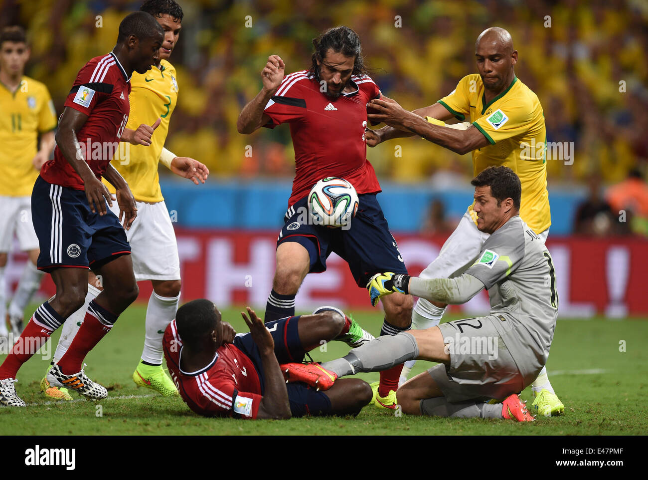 Fortaleza, Brazil. 04th July, 2014. Goalkeeper Julio Cesar (R) of Brazil and Mario Yepes (C) and Cristian Zapata (down) of Colombia vie for the ball during the FIFA World Cup 2014 quarter final match soccer between Brazil and Colombia at the Estadio Castelao in Fortaleza, Brazil, 04 July 2014. Photo: Marius Becker/dpa/Alamy Live News Stock Photo