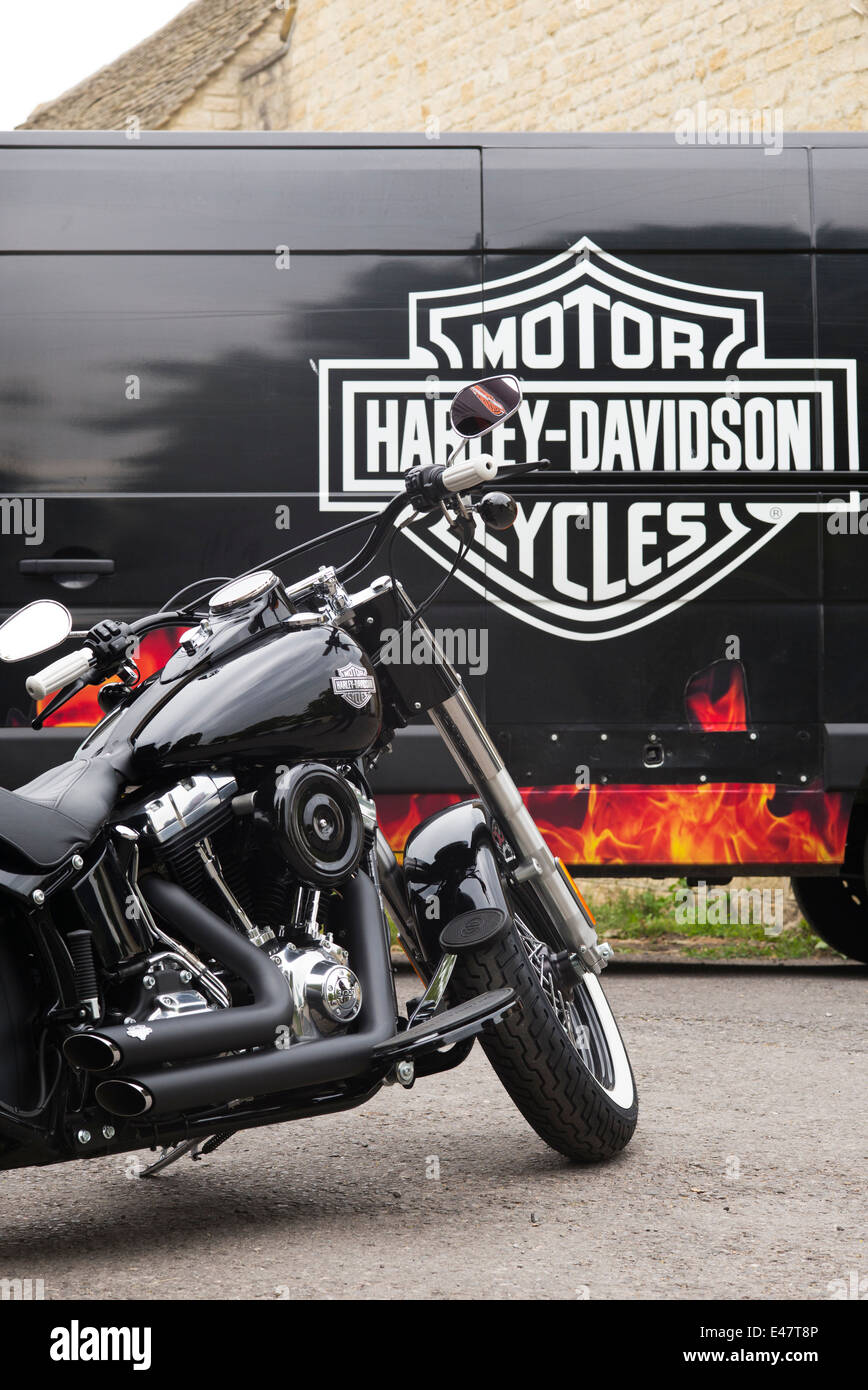 Harley Davidson motorcycle in front of van with Harley Davidson logo Stock Photo