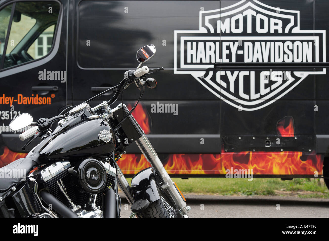 Harley Davidson motorcycle in front of van with Harley Davidson logo Stock Photo