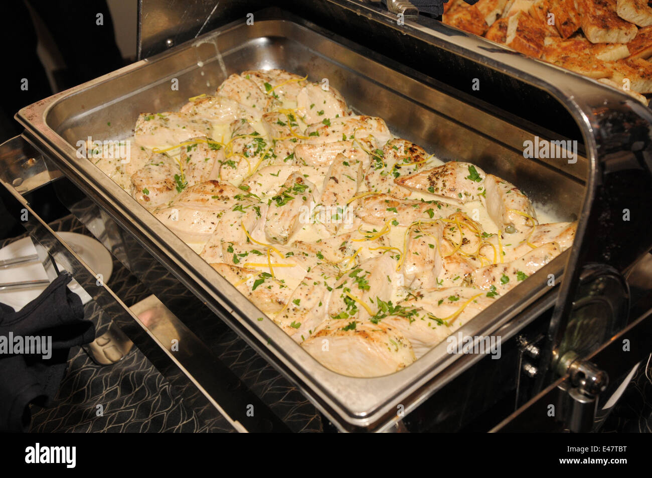 Caterer brought some delicious chicken for the wedding buffet Stock