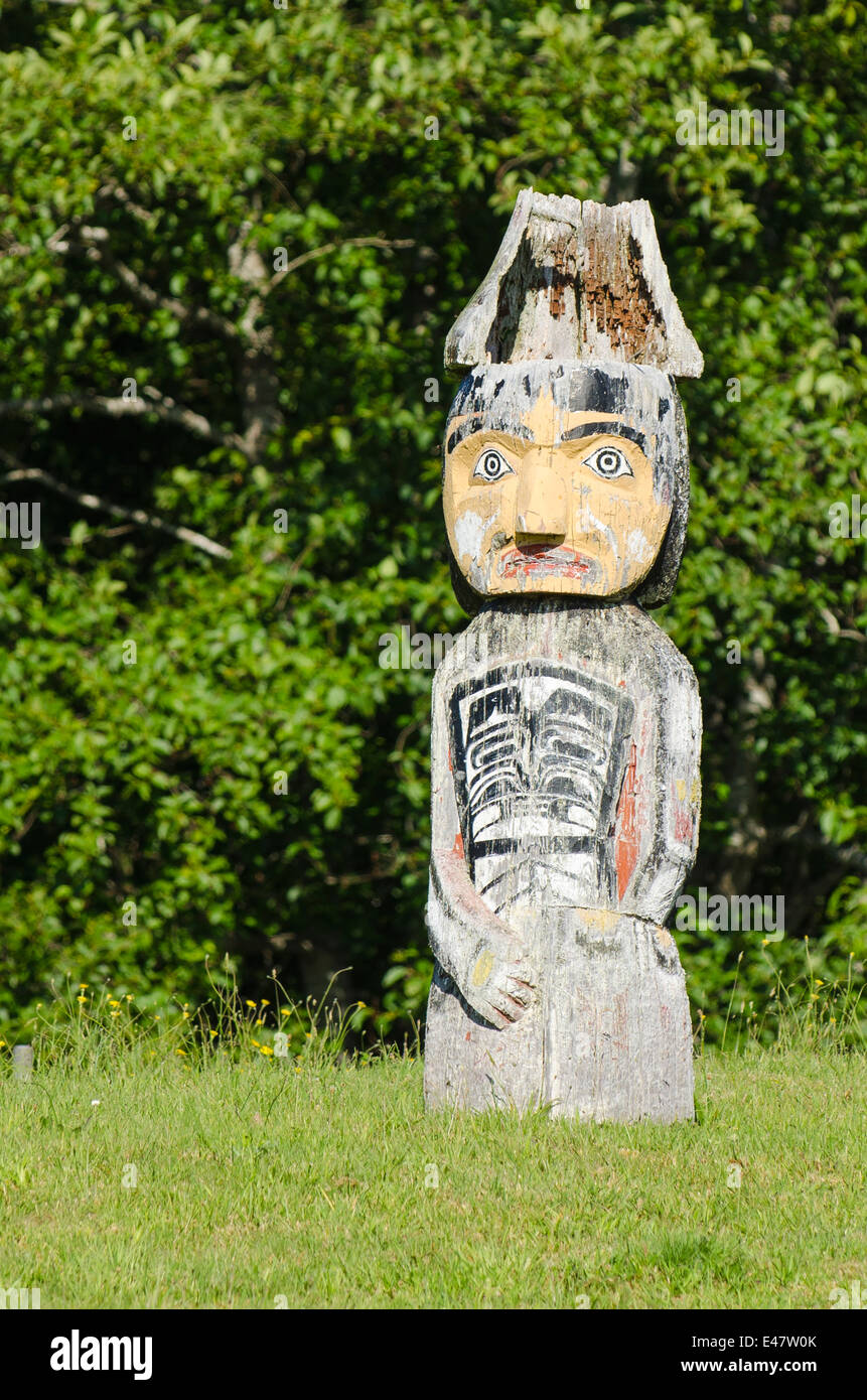 First Nation native totem story monument pole in cemetery in Alert Bay, Cormorant Island, BC, British Columbia, Canada. Stock Photo