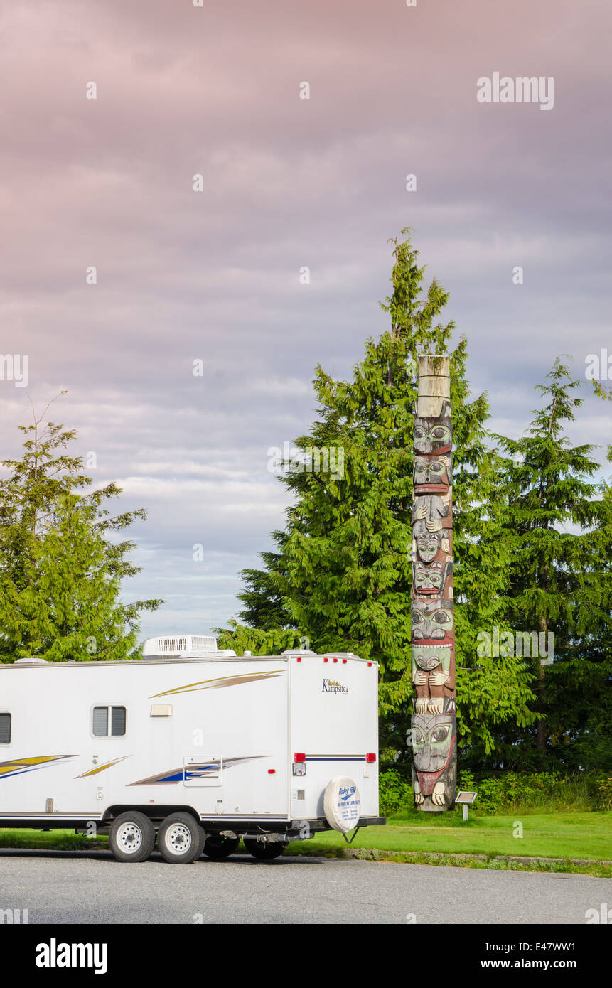 Travel trailer near the Chief's totem pole in Service Park, Prince Rupert, British Columbia, Canada. Stock Photo