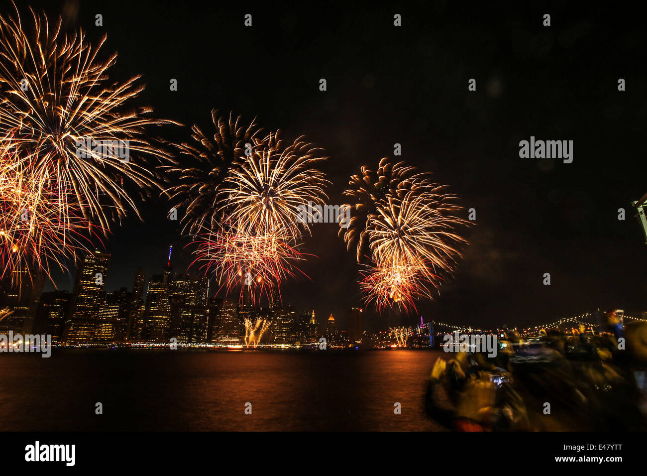New York, USA. 4th July, 2014. Fireworks explode over the East Rive in ...