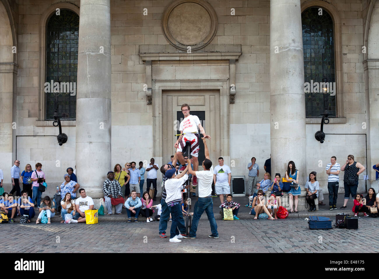 A street performer on a unicycle in front of St Paul's Church (commonly known as the Actor' Church) Covent Garden Market Stock Photo