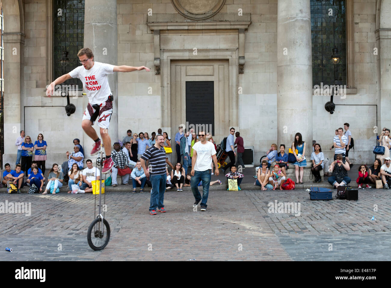A street performer on a unicycle in front of St Paul's Church (commonly known as the Actor' Church) Covent Garden Market Stock Photo