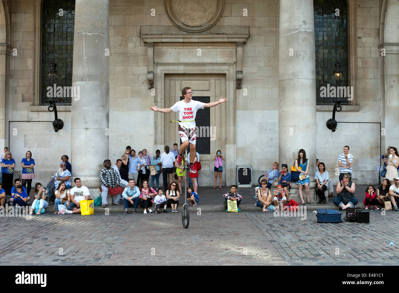 A street performer on a unicycle in front of St Paul's Church (commonly known as the Actor' Church) Covent Garden Market Stock Photo